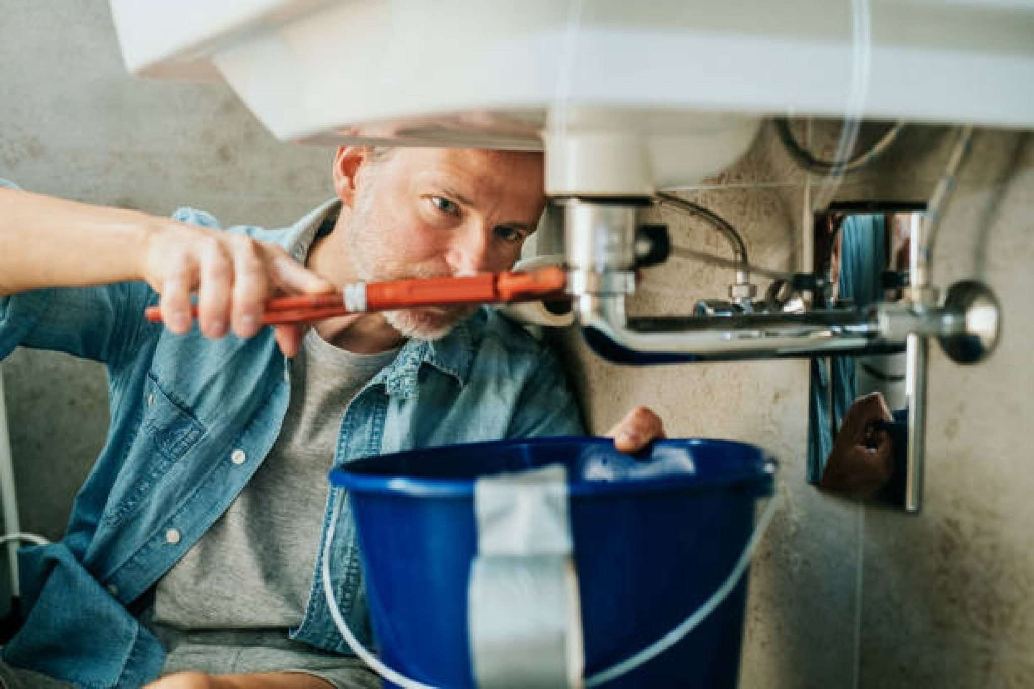 Fix a leak in a sink using a pipe wrench