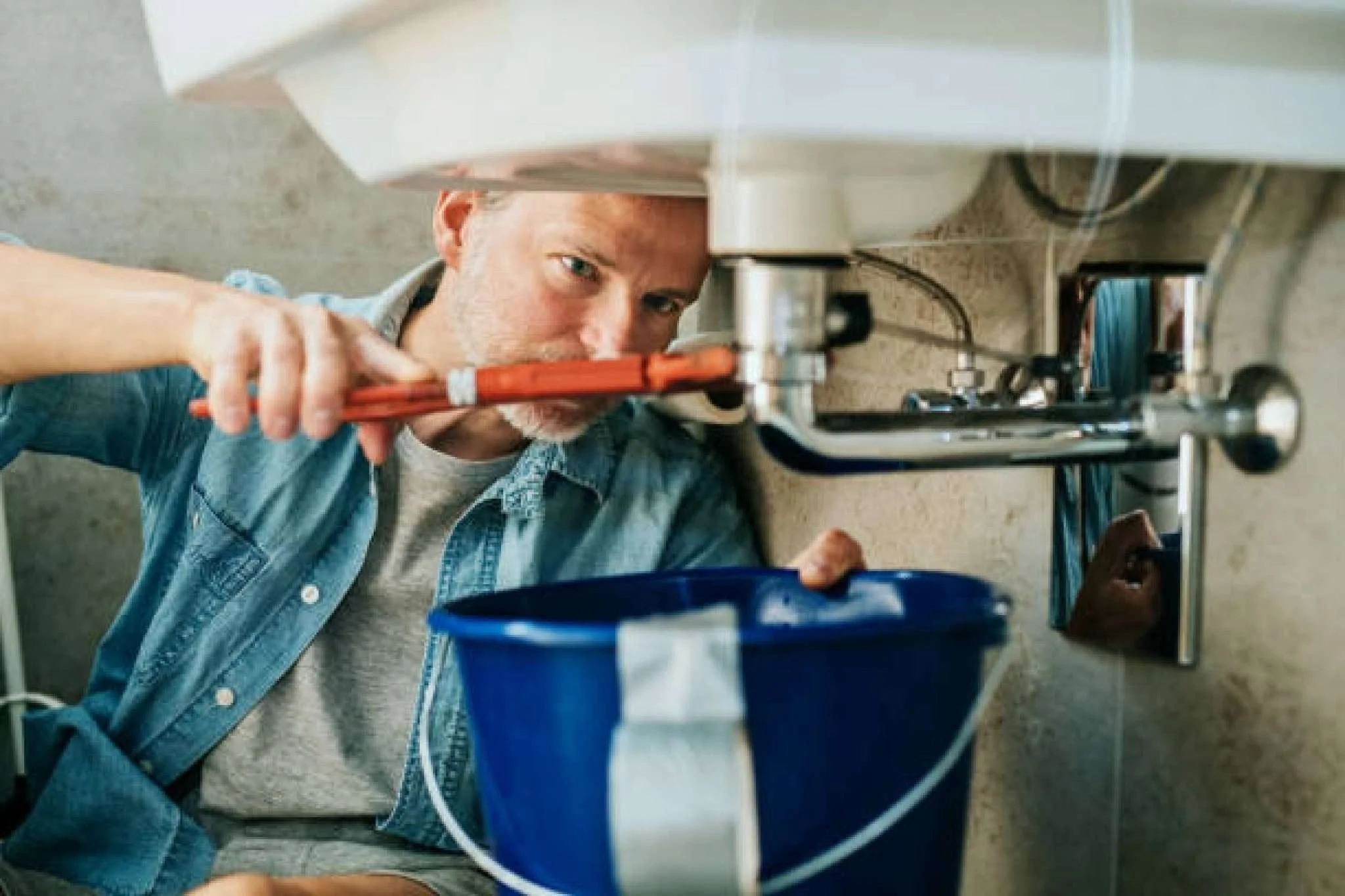 Fix a leak in a sink using a pipe wrench